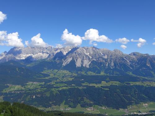 an aerial view of a mountain range with forests and mountains at Landhaus Wieser in Ramsau am Dachstein
