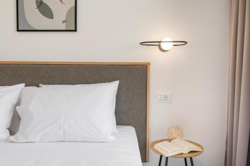a bedroom with a bed with a lamp and a book at Kallistefan in Kissamos