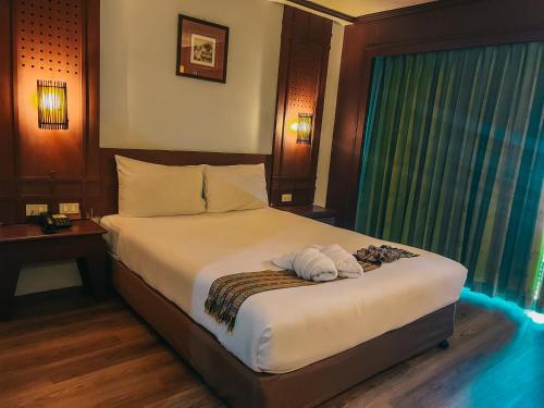 Neo Hatyai Hotelにあるベッド