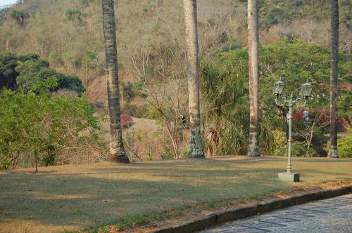 a park with a street light in the grass at Fazenda Cachoeira Grande in Vassouras