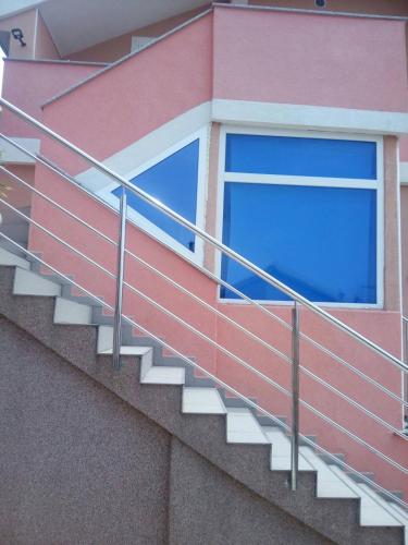 a window on the side of a building with stairs at Apartment Olive in Jovići