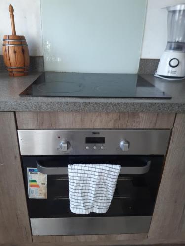 a kitchen oven with a towel hanging from it at Our Guests Are Royal (KE) in Higham Ferrers