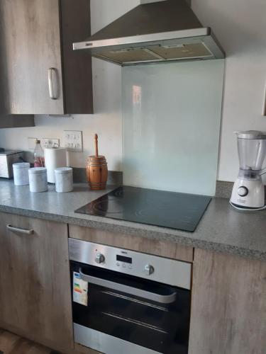 a kitchen with a stove and a counter top at Our Guests Are Royal (KE) in Higham Ferrers
