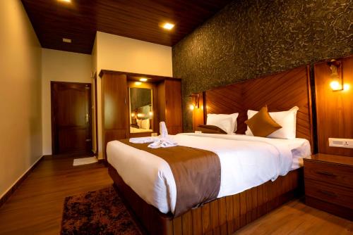 a bedroom with a large bed in a room at Stephen's Legacy in Vattavada