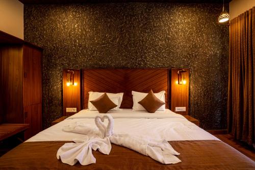 a bedroom with a bed with a towel on it at Stephen's Legacy in Vattavada