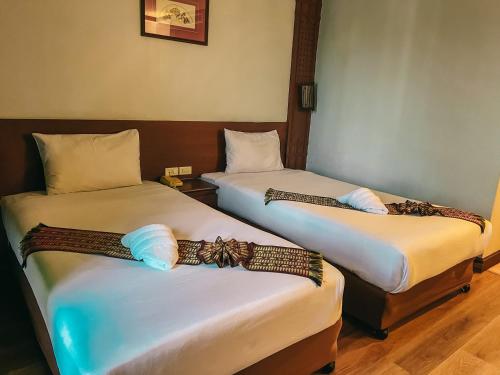 Neo Hatyai Hotelにあるベッド