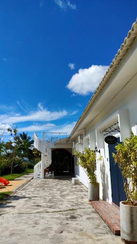 a white building with a staircase leading to a tunnel at Bean & Bed Guesthouse in Muar