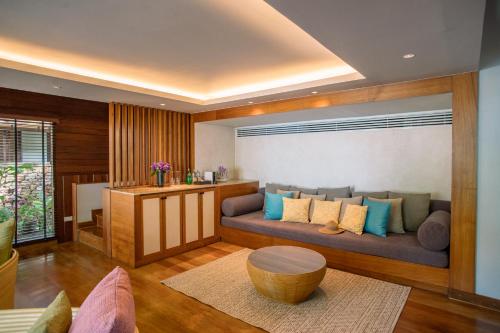 a living room with a couch and a table at The Tubkaak Krabi Boutique Resort in Tab Kaek Beach