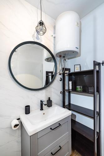 a bathroom with a sink and a mirror at Apartment Helena Rovanjska in Rovanjska