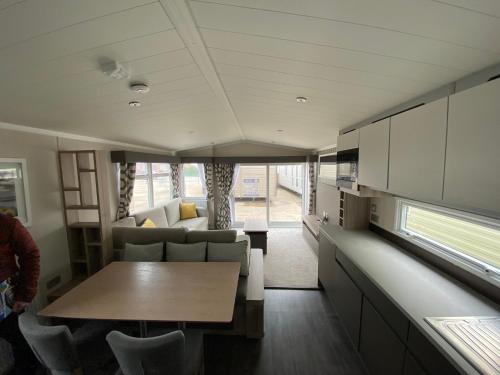 a kitchen and living room in a tiny house at 17 Wildflower Meadow in Chapel Saint Leonards