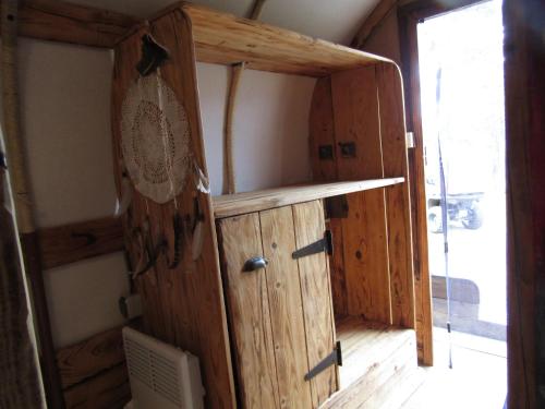 a wooden cabinet in a room with a window at La Bergerie du Plateau in Cros-de-Géorand