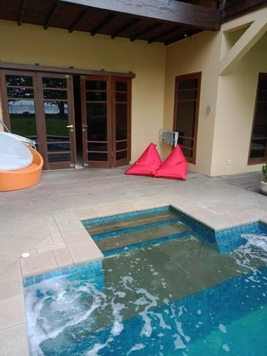 a swimming pool in the middle of a house at The BeachHouse Tanjung Lesung in Cipakus