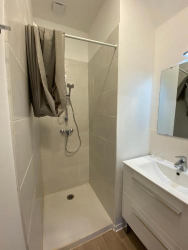 a bathroom with a shower and a sink at Hotel Le Chalet in Sainte-Marie-de-Campan