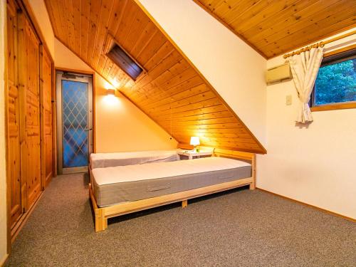 a bedroom with a bed in a attic at びわ湖ハイドアウト in Takashima