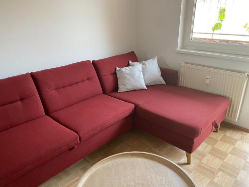 a red couch with two pillows on it in a room at Gamlitz - RaStra Top 7 in Gamlitz