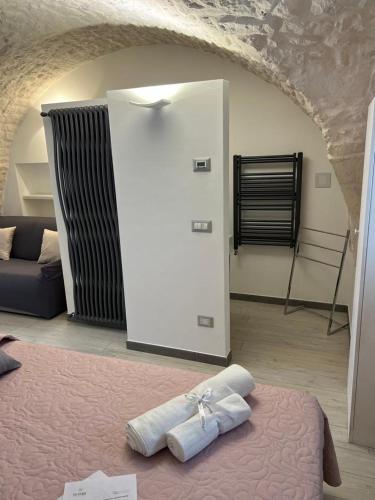 a room with a bed and a white refrigerator at LUXURY ROOM CASSESE in Ceglie Messapica