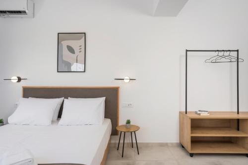 a bedroom with a bed and a table and a mirror at Kallistefan in Kissamos