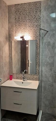 a bathroom with a sink and a mirror at Алюр студио Приморско - Studio Allure Primorsko in Primorsko