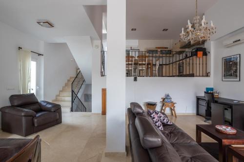 two images of a living room with a couch and a table at Casa Curumbico in Almuñécar