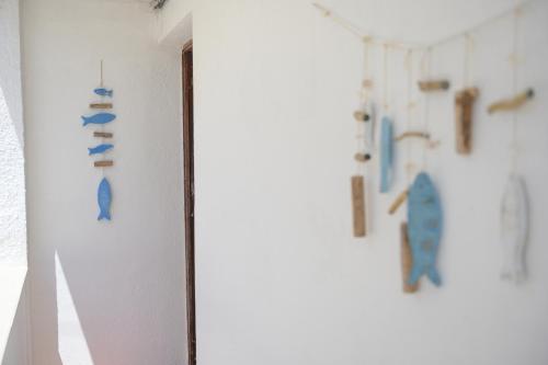 a room with a white wall with a bunch of objects on the wall at Salento incantevole alloggio fronte mare in Marittima
