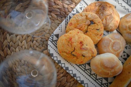 a plate of muffins and buns on a table at Salento incantevole alloggio fronte mare in Marittima