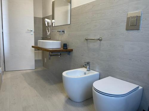 a bathroom with a toilet and a sink at Calafato Guest House in Favignana