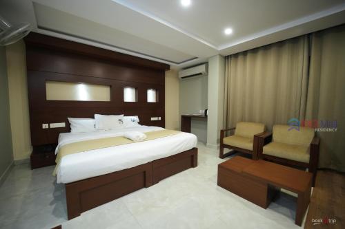 Кровать или кровати в номере Bigmall Residency