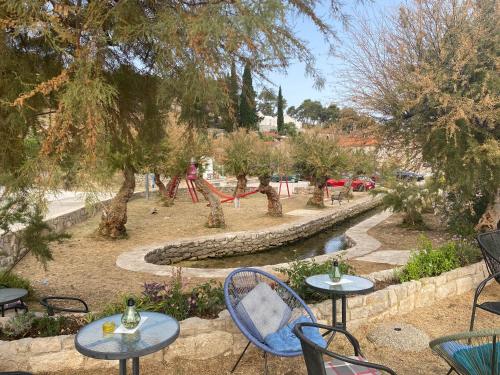 a park with tables and chairs and a playground at Apartman Silna your new home with terrace and garden in Bobovišća