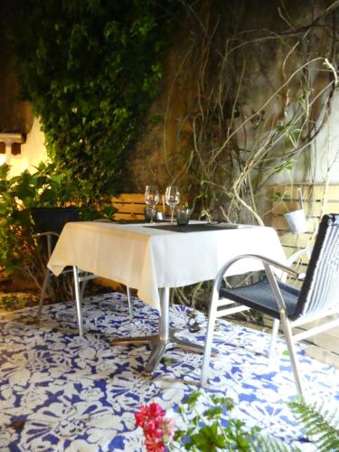 a table and a chair on a patio at Le 9 en Cuisine in Rabastens