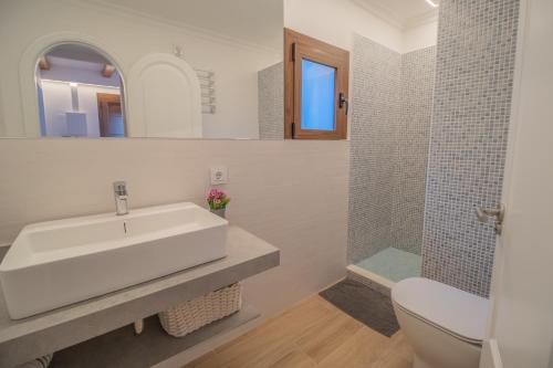 a bathroom with a sink and a toilet and a shower at G014 Paraiso by Mallorca Villa Selection in Alcudia