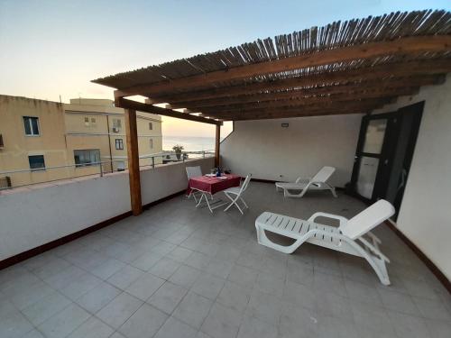 a patio with a table and chairs on a roof at Case Vacanze "Residenze Trapanesi" in Trapani