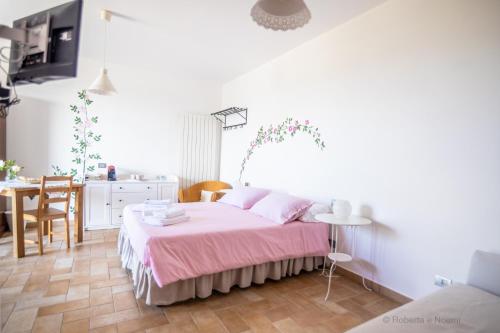 a bedroom with a bed and a table and a kitchen at Orvieto Rocca Fiorita in Orvieto