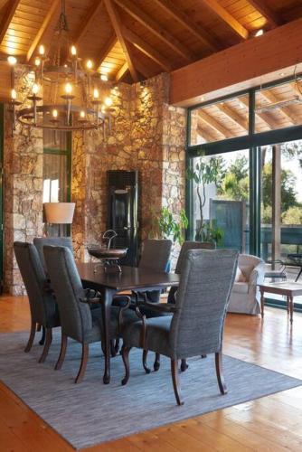 a dining room with a table and chairs at AGROLOGY LUX - 4 BEDROOM Luxurious villa on an Agricultural Haven Retreat in Sálakos