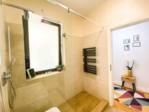 a bathroom with a shower and a window at 8ight in Braşov