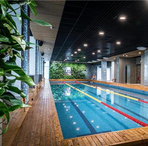 a large swimming pool in a building at 11 Pine View in Ķesterciems
