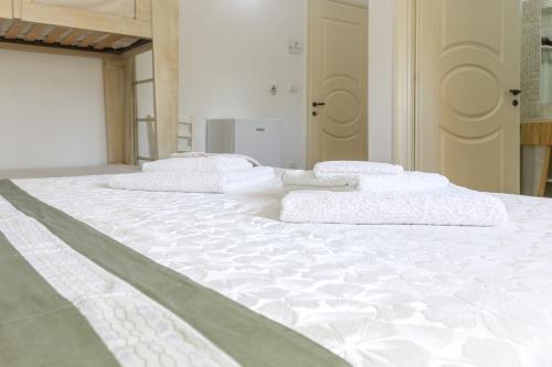 a large white bed with four pillows on it at Blue And Blue City in Ugento