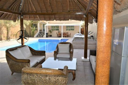 a patio with chairs and a swimming pool at Dar 66 Pool Villa with Jacuzzi in Ras al Khaimah