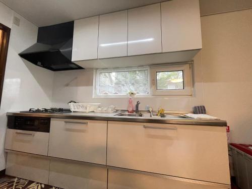 a kitchen with a sink and a stove at 京樽3号 1棟貸切 一軒家 3-Bedrooms Duplex Private Villa KYOTARU3 in Otaru