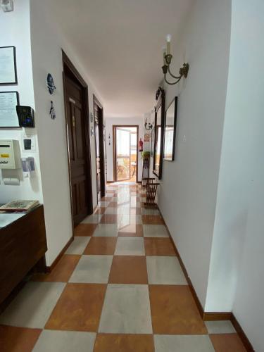 a hallway of a house with a checkerboard floor at Don Paula in Córdoba