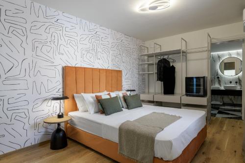 a bedroom with a bed and a wall with a pattern at Meno Suite with Private Terrace - Jaccuzzi, Acropolis View in Athens