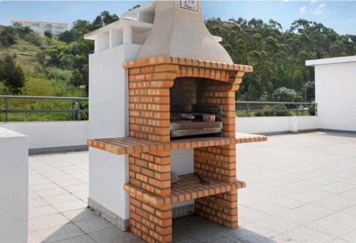 a brick oven sitting on top of a patio at Fabulous Apartment Nazaré in Nazaré