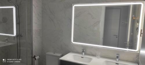 a bathroom with a sink and a mirror and a toilet at Appartement Baviera Hills - Torre del Mar - Costa del Sol in Caleta De Velez