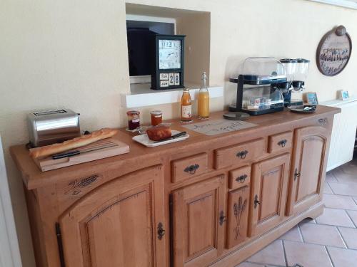 a kitchen with a wooden counter top with a blender at Au Bord de L'Eau in Écluzelles