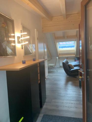 a room with a desk and a living room at Tolles Loft in den Tessiner Bergen in Corcapolo