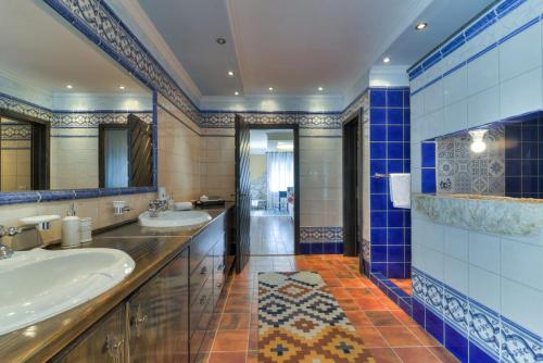 a bathroom with two sinks and a large mirror at Villa Mate and Franka in Bribir