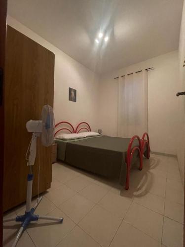 ein Schlafzimmer mit einem Bett und einer Schere in der Unterkunft Alba Holiday House , Casa Vacanze Ricadi in Santa Maria