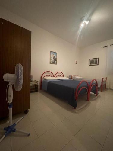a bedroom with a bed and a fan in it at Alba Holiday House , Casa Vacanze Ricadi in Santa Maria