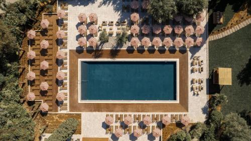 an overhead view of a swimming pool with umbrellas at Cook's Club Corfu - Adults Only in Gouvia