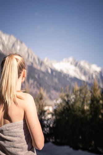 a woman standing in front of a mountain at Vierbrunnenhof in Anterselva di Mezzo