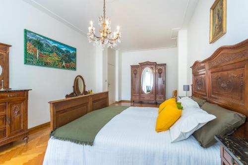 a bedroom with a large bed with yellow pillows at Crocetta Family Apartment by Wonderful Italy in Turin